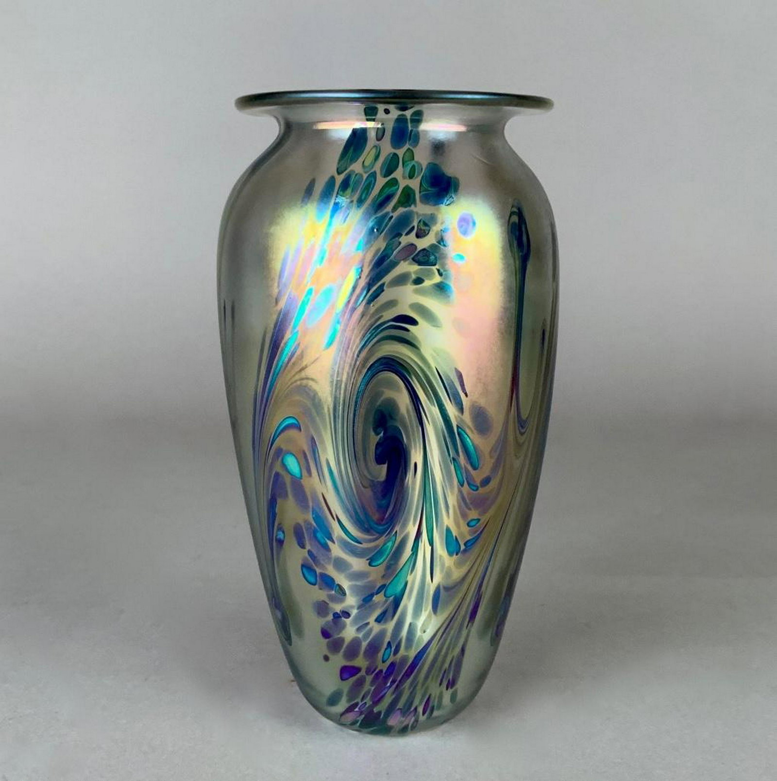 Robert Eicholt Art Glass Vase, 1999: Robert Eicholt Art Glass Vase, 1999Of baluster form in translucent iridescent glass with a swirling pulled and trailed design in blue, purple and green. Signed Eicholt, dated 1999, VSCH. 7.5 in.h. x 4