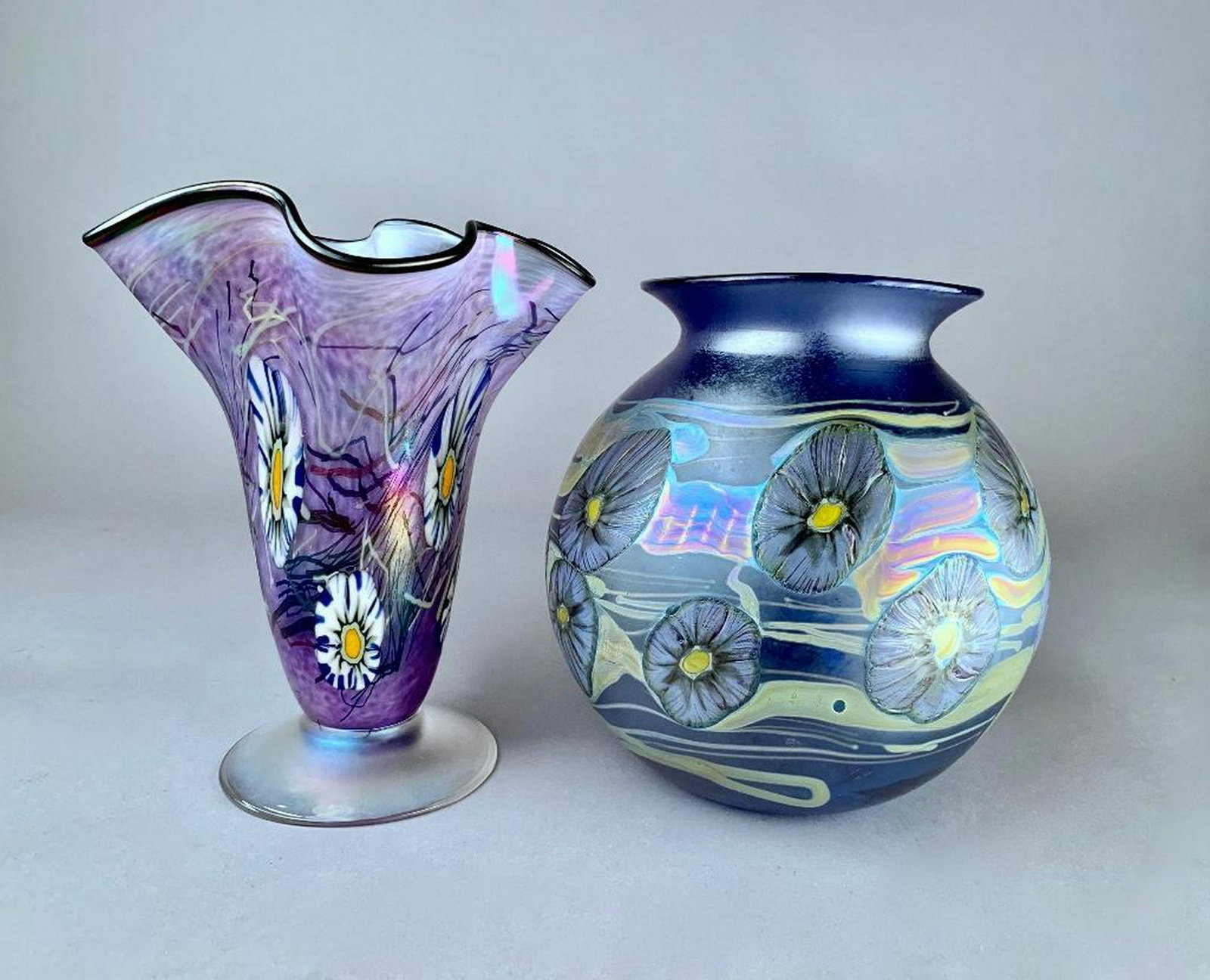 Two Herb A.Thomas Studio Glass Vases, Modern: Two Herb A.Thomas Studio Glass Vases, Modern A globular form in iridescent blue decorated with floral forms and pulled and trailed iridescence, signed HAT and dated '00, together with a tapering conic