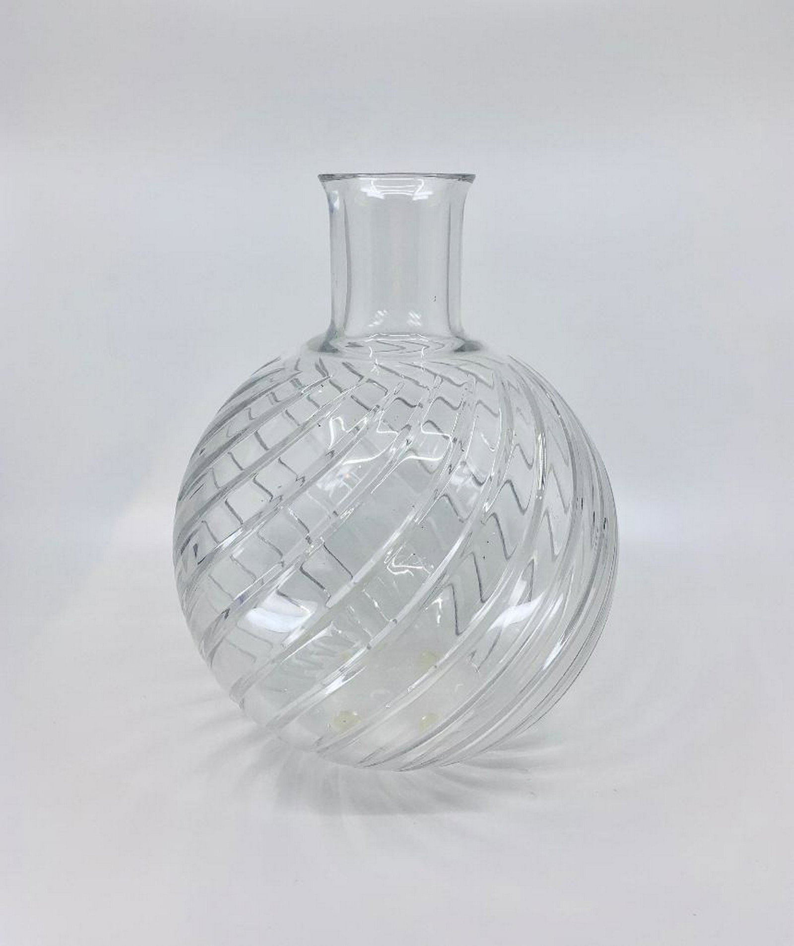 Baccarat Crystal Vase: Spherical form with cylindrical neck and swirl cut design. Acid stamp signature. 10.25 in.h. Condition: Good with no damage or repair.
