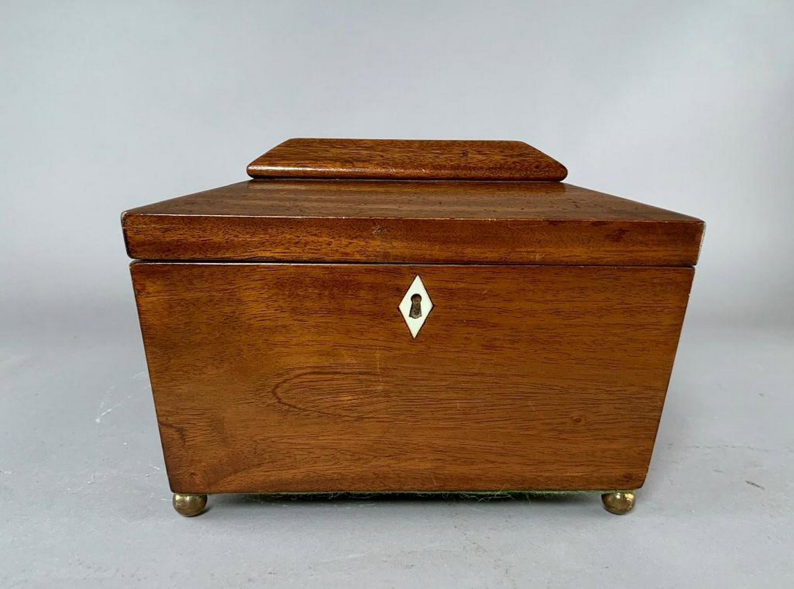 Antique Tea Caddy: Coffer shape caddy on round feet, hinged lid, two interior compartments with lids, bone knobs, approx 6.75 x 10 x 5.5. Bone escutcheon. Condition: Very good, few older restorations.