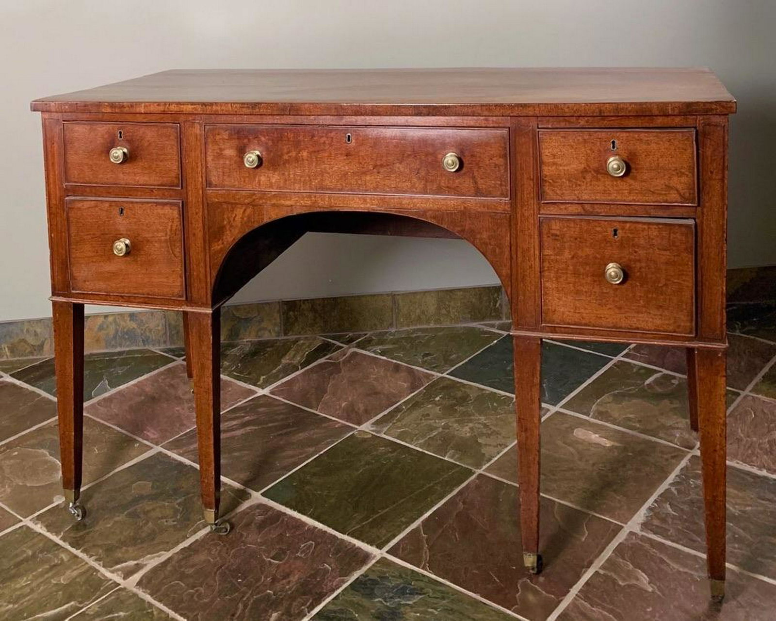 George III Mahogany Diminutive Sideboard,18thc.: Rectangular top over conforming case with two pairs of short drawers centering a long frieze drawer, raised on squared tapering legs ending in casters. 31 in. h. x 46.25 in. l. x 21 in. d. Condition: 