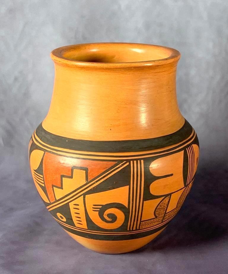 Hopi Redware Pottery Jar: Hopi Redware Pottery Jar, shouldered form in terracotta decorated around the form with geometric designs, with burnished surface. Signed with a flower and leaf monogram. 7.25 in. h. Condition: .5 in.