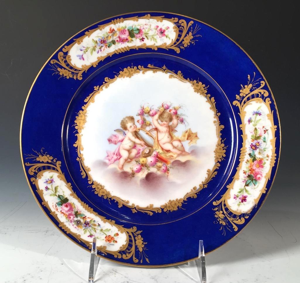 Sevres Hand Painted Cabinet Plate, c.1873: Sevres Hand Painted Cabinet Plate, c.1873, decorated with a pair of winged cherubs, one holding a mirror while the other admires himself with a floral swag held to his head, with cobalt blue border de