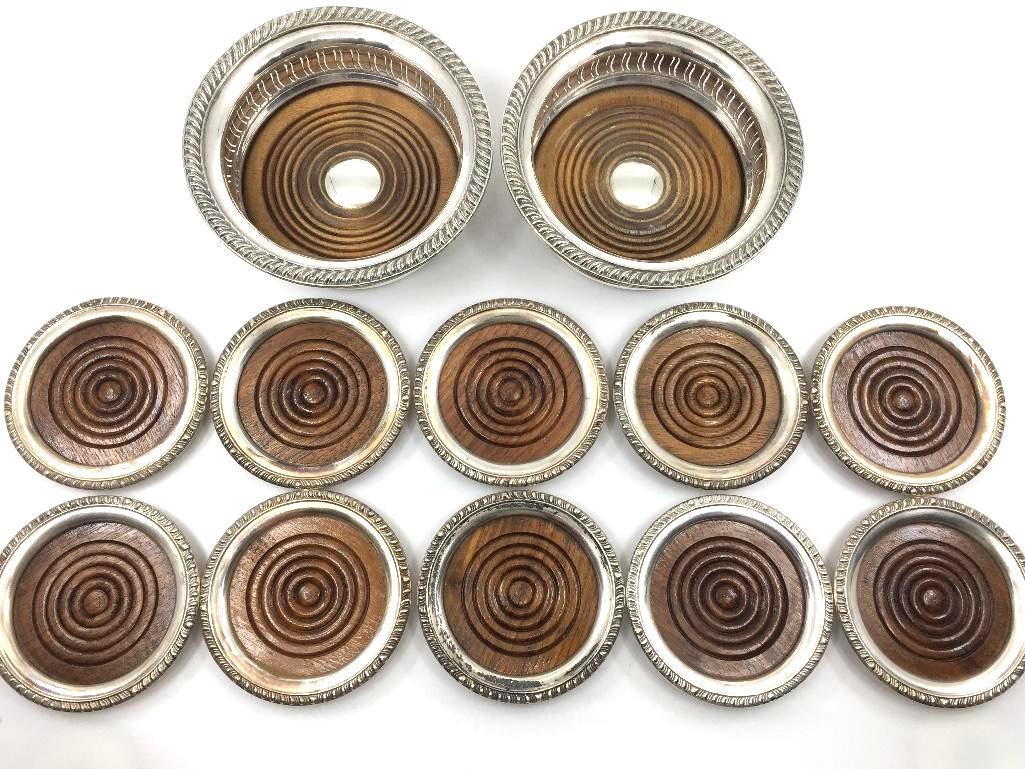 Assorted Coaster Lot: Assorted Coaster Lot, comprising two English silver wine coasters with reticulated sides and wood base inserts, together with 10 wine individual coasters with wood base inserts. Bottle coasters 5.75 i