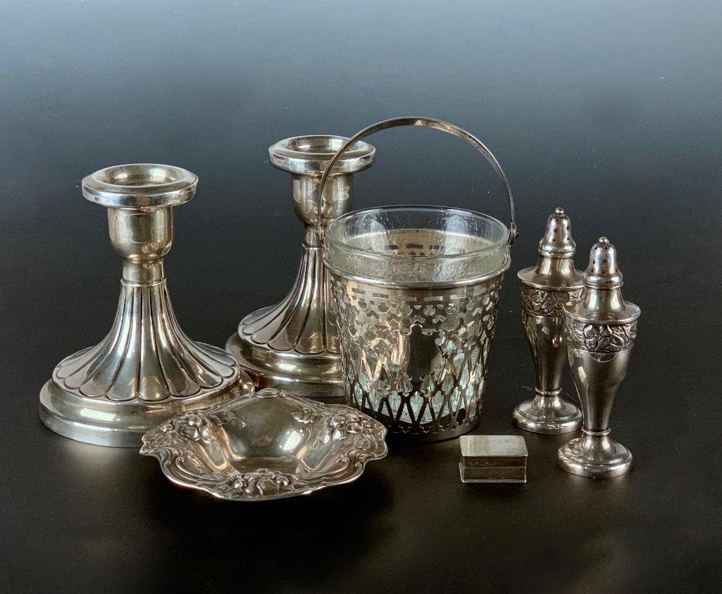 Assorted Sterling Silver Lot: Comprising a pair of candlesticks, bail handled openwork basket with glass liner, pair of Mexican silver salt and pepper shakers, Gorham candy dish and small pill box.19.38 oz. troyCandlesticks 4.5 in