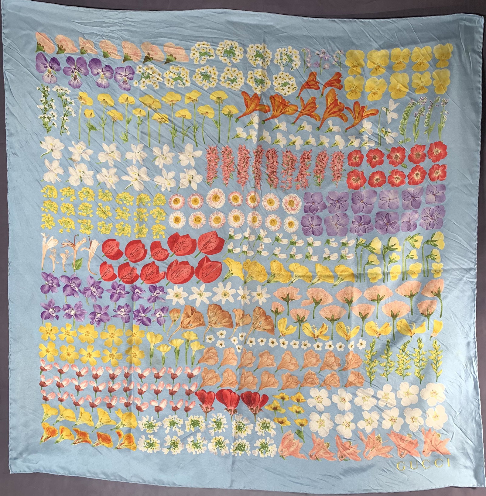 Vintage GUCCI silk scarf ‘Flora’ design by V.: Vintage GUCCI silk scarf ‘Flora’ design by Vittorio Accornero botanical scarf, sky blue background with green, pink, blue, yellow, and red decoration. Made of silk twill. Hand rolled edges. Includ