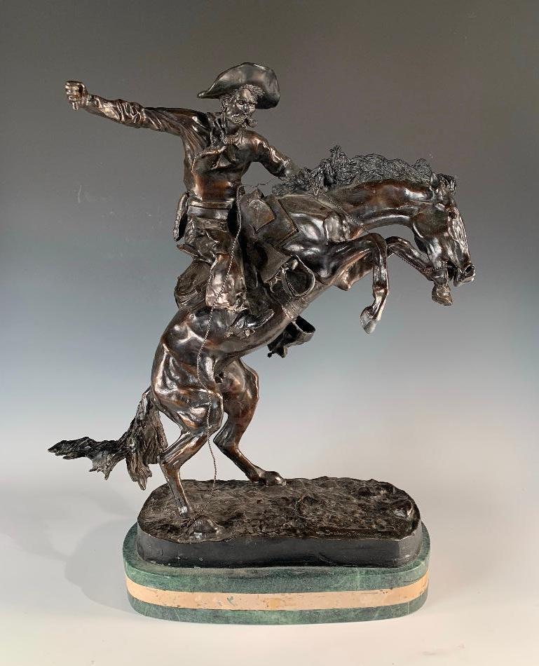 After Frederic Remington (American 1861-1909): After Frederic Remington (American 1861-1909) Bronco Buster, bronze with dark blackish brown patination, signed, raised on marble base. 21 in.h. x 19 in. l. x 7 in. d. Condition: Very good with wh
