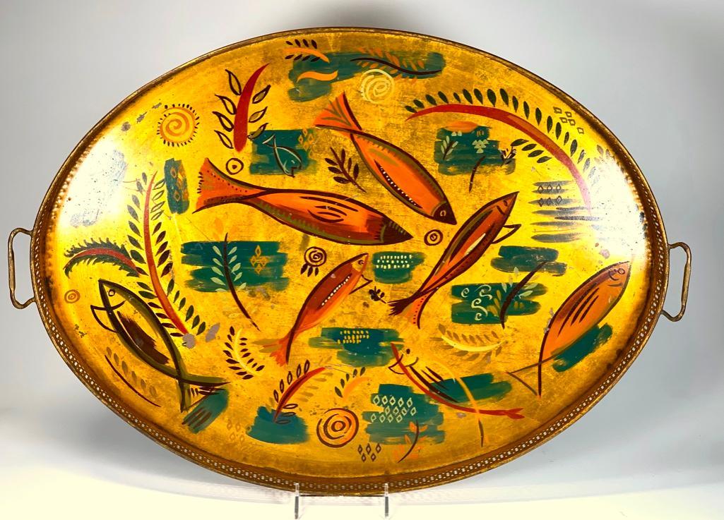 Georges Briard Tole Peinte Tray: Georges Briard Tole Peinte Tray, oval galleried form hand painted with fish and underwater vegetation in green, iron red and brown on a gilded ground. Signed on the obverse. 25.5 x 19 in. Condition: S
