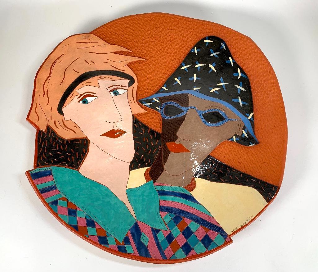 David Stabley Ceramic Wall Plaque: David Stabley Ceramic Wall Plaque (American, Contemporary) Freeform circular glazed terracotta wall plaque decorated with busts of a woman and a Pierrot figure wearing sunglasses, signed and dated 198
