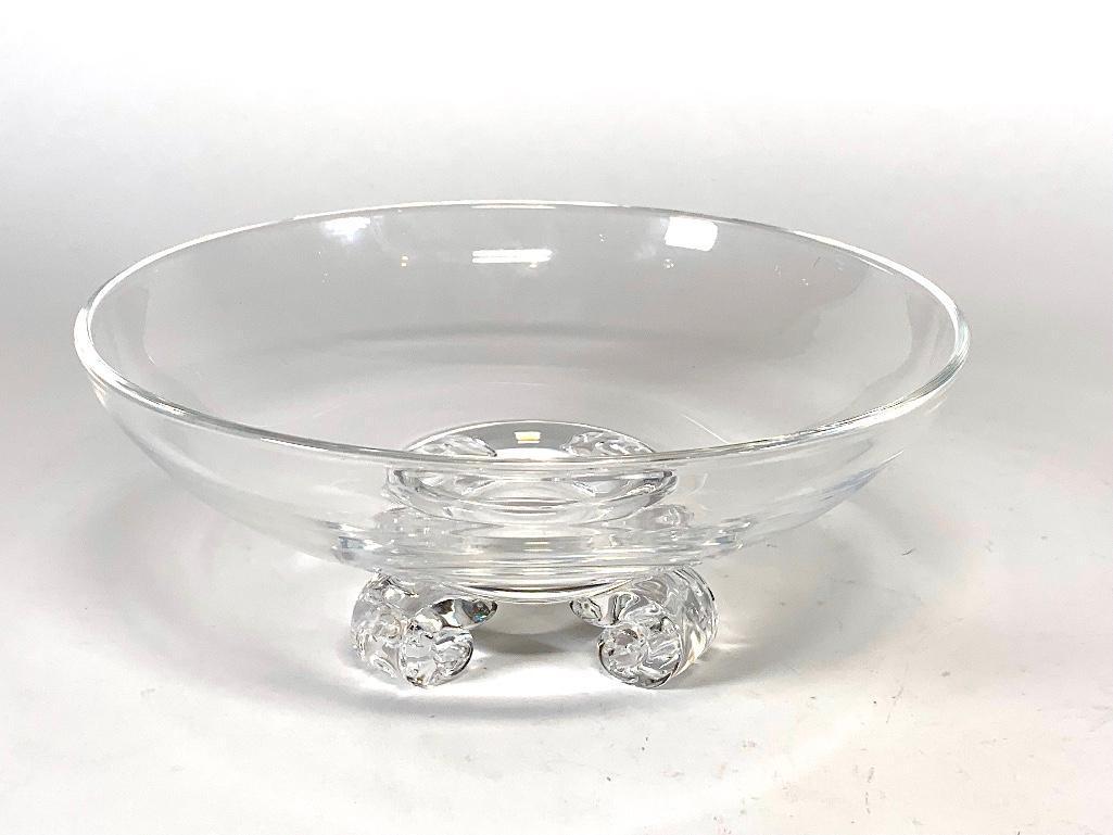 Steuben Crystal Bowl: Steuben Crystal Bowl, in colorless glass, of circular form with four scrolled feet. Signed Steuben with incised signature. 8 in. dia. Condition: Wear and scratches to bottom edge of feet, one foot wit