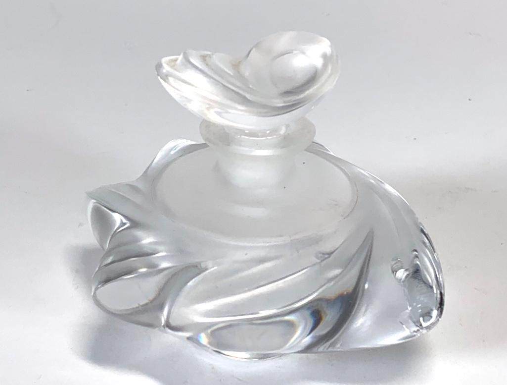 Lalique Samoa Pattern Perfume Bottle: Lalique Samoa Pattern Perfume Bottle, swirled design in molded and frosted glass. Signed Lalique France with incised signature, 4.25 in. w. Condition: large chip to one edge.