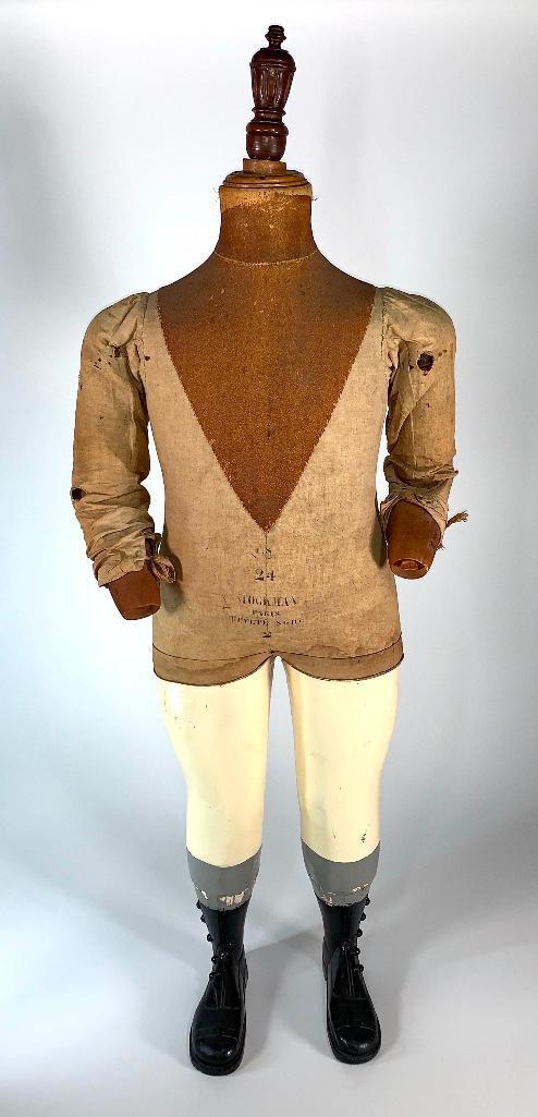 Stockman Paris Antique Dress Form Mannequin: Stockman Paris Antique Dress Form Mannequin, full body form with articulated wood arms, linen covered body with painted wood legs and carved button up boots, 33 x 13 x 8 in. Condition: Lacking hands, 
