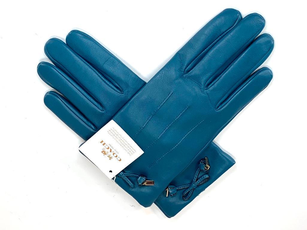 Pair of New with Tags Coach Leather Gloves: Pair of New with Tags Coach Leather Gloves, in teal leather with decorative bellflower bow and pendant Coach logo tag, with merino wool lining, size 7.5. Condition: Very good, unworn.