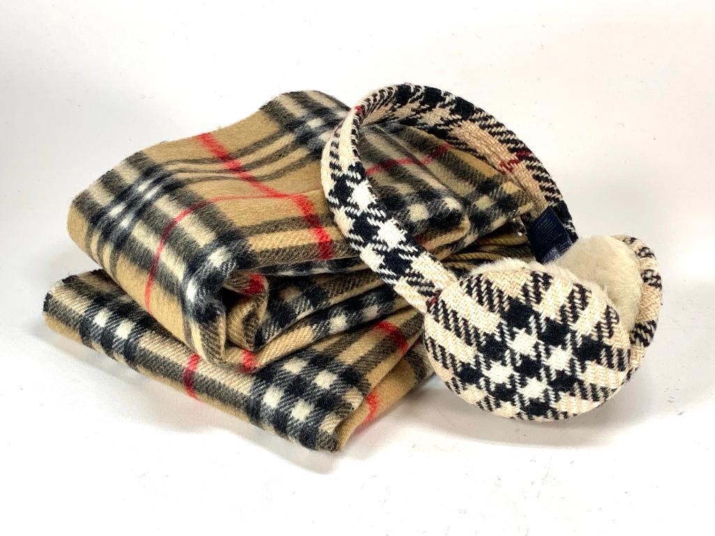Burberry Lot: Burberry Lot, His and Hers signature plaid 100% cashmere scarves and a pair of wool and shearling earmuffs. Scarves 52 x 12 in. Condition: One scarf worn with some small holes, the other in good condi