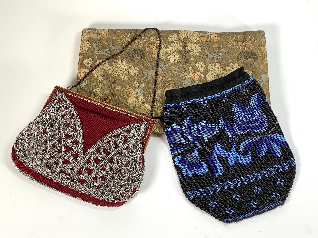 Three Antique Evening Bags: Three Antique Evening Bags, a beadwork bag with a blue floral design on black, silk satin interior, a marcasite beaded frame bag with chain handle and a chinese woven silk bag. 7.5.5 in. Blue and Blac