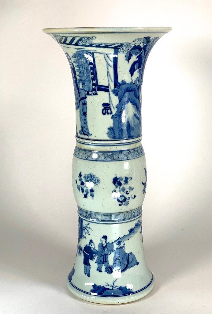 Chinese Khangxi Style Blue and White Gu Vase: Chinese Khangxi Style Blue and White Gu Vase, decorated with scholars and attendants at various pursuits, with six character mark. 18.5 in.h. x 8.5 at opening Condition: Very good with frit marks