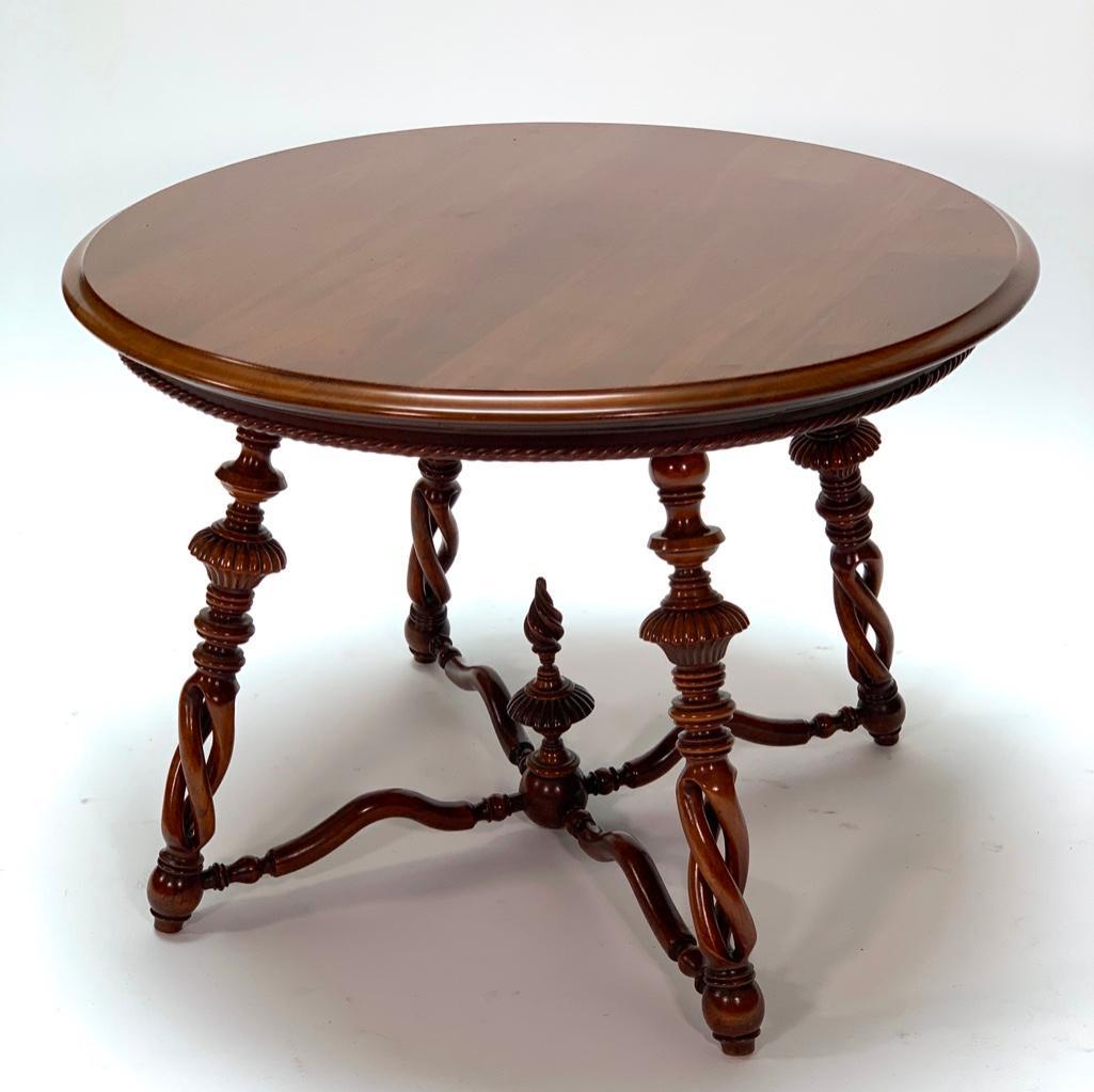 Mahogany End Table, Modern: Circular top on splayed turned legs joined by undulating stretcher and turned finial. 24 in.h. x 34 in. dia.