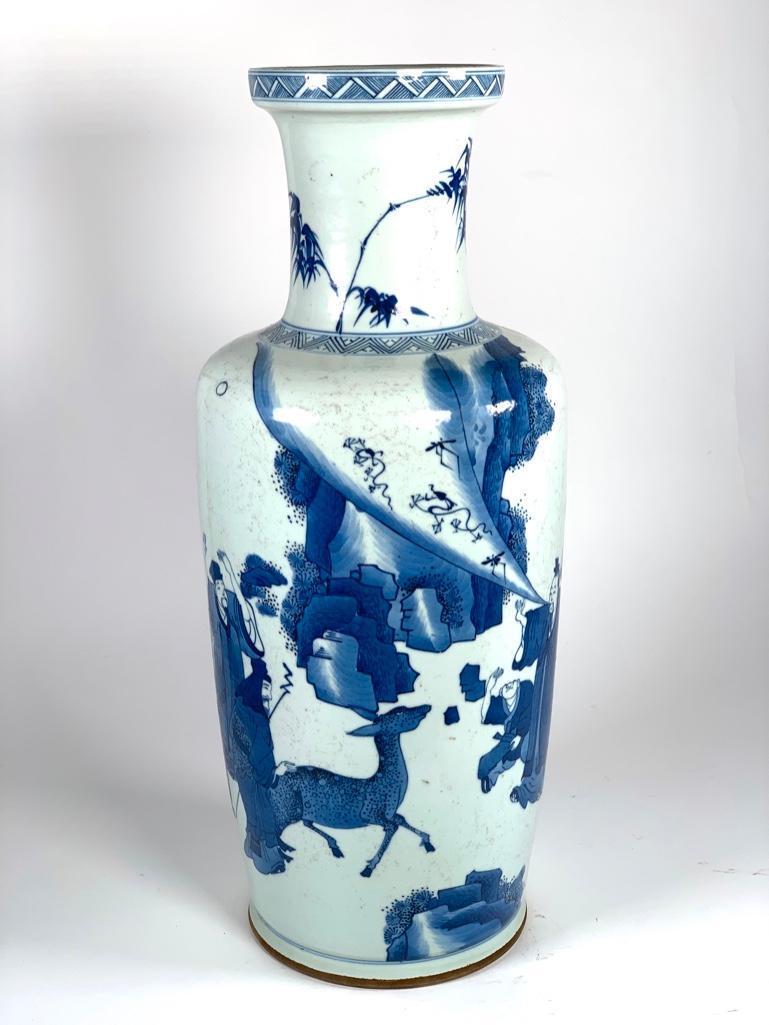 Chinese Blue and White Vase, Qing Style: Shouldered baluster form decorated white ground with immortals and deer in landscape. Tapered shape with drop waisted shoulder, tall neck with banded edge at rim. Bottom with double ring mark. 17.75 x