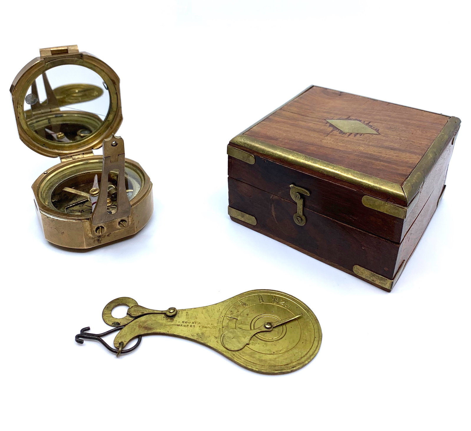 Two Brass Mechanical Instruments: Comprising an English Brass Bunton Stanley compass in campaign style case with brass inlay, together with an antique English brass postal scale by J.Cooker and Son. Dimensions: Scale: 5.75 x 2.75 in.,