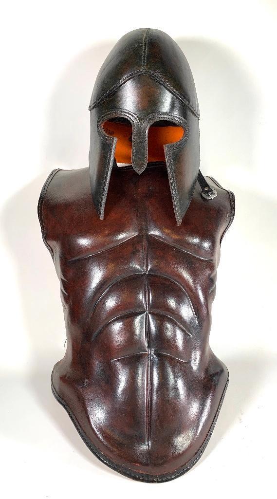 Athenian Leather Breastplate and Helmet: Hand sewn leather breastplate with leather helmet, modern. With painted metal display pole and base. Dimensions: Breastplate 25 in.l. Helmet 12 in.h.