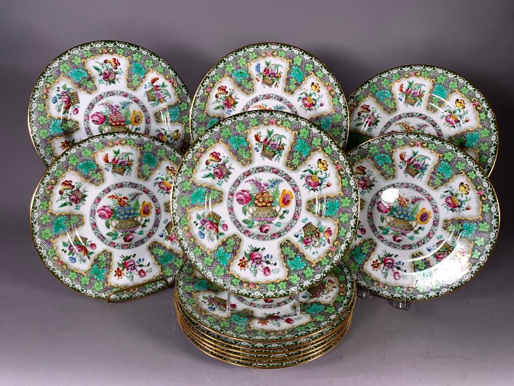 Twelve Spode Copeland Dinner Plates: Twelve Spode Copeland Dinner Plates, colorful exuberant decoration of floral baskets and floral sprigs on a green and white border. Retailed by Davis and Collamon, 5th Ave, New York. Dimensions; 10.25