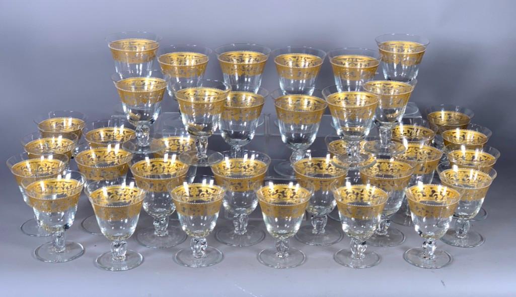 Set of Thirty-five Crystal Goblets with Gilt and Enamel: Set of Thirty-three Crystal Goblets with Gilt and Enamel Decoration, in Venetian style, comprising 18 water goblets and 17 white wine goblets, all decorated with a foliate scroll and female mask patte