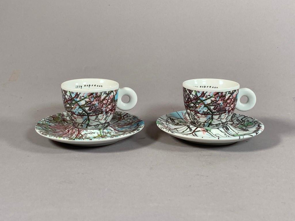 Two Illy Collection Robert Rauschenberg World Espresso: Two Illy Collection Robert Rauschenberg World Espresso Cups and saucers, 1990's, limited edition by Mitterteich Bavaria, with large underglaze Rauschenberg signature, retailed by the Guggenheim Museum