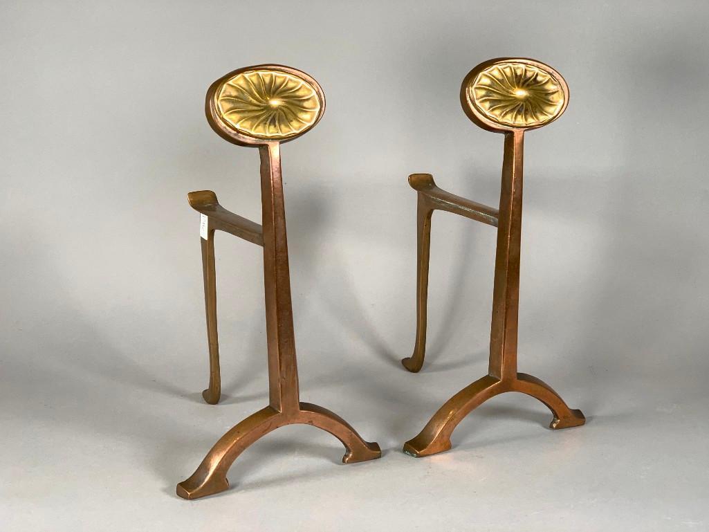 Pair of Modern Brass Andirons: Pair of Modern Brass Andirons, in two pieces, with stylized flower form on copper colored brass base. Dimensions: 11.5 x 6 x 7.5 in. Condition: Very good with age related wear.