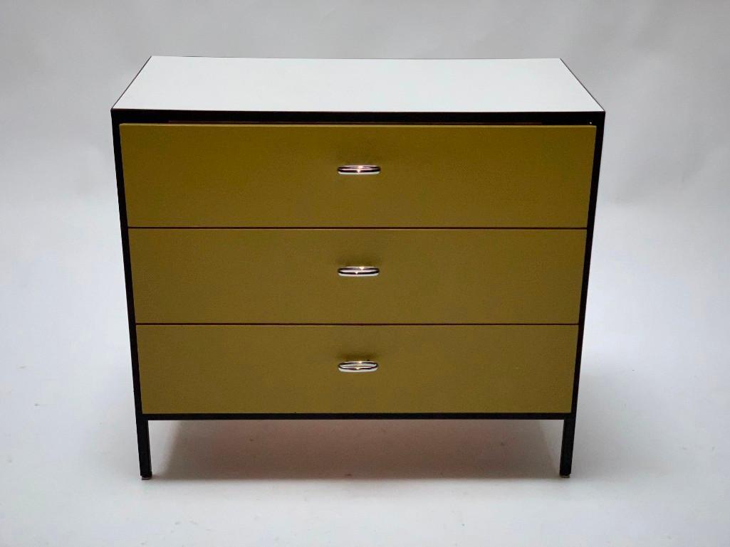 George Nelson For Herman Miller Chest of Drawers: George Nelson For Herman Miller Chest of Drawers, c. 1950-60, steel frame with painted wood, the rectangular white laminate top over three frieze drawers enameled in mustard, the sides in green, with 