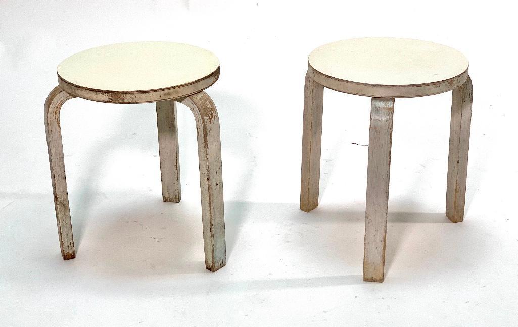 Alvar Aalto L-Leg Stools from the studio of Leza McVey: Pair of Alvar Aalto L-Leg Stools, Model 60, in old gray paint and with white laminate tops. Dimensions: 17.5 in. h. x 13..5 in. dia. Condition: As is, with wear from use. Sturdy. From the studio of ar