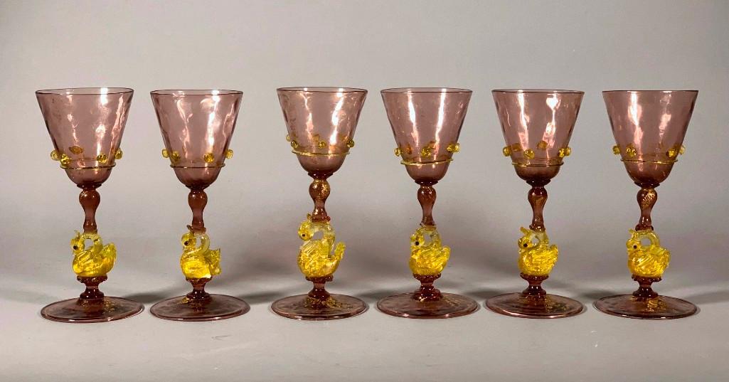 Lot of Six Venetian Glass Wines: Lot of Six Venetian Glass Wines, in amethyst glass with gilt foil inclusions, tapering bowls with applied prunts and thread in gold, on gold swan form stems and circular foot. Dimensions: 6.5 in.h. Co