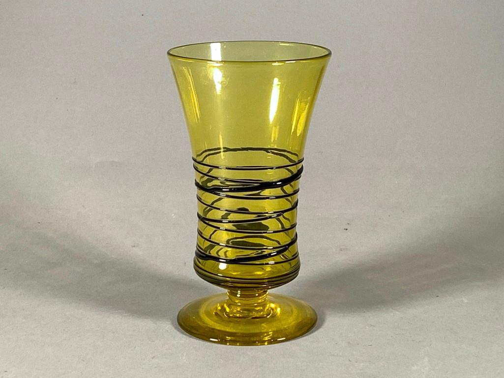 Steuben Bristol Yellow Threaded Glass Vase: Steuben Bristol Yellow Threaded Glass Vase, flared form on circular foot in bright yellow glass with applied black threading around the form. Acid stamped signature. Dimensions: 6 in.h x 3.5 in. dia. 