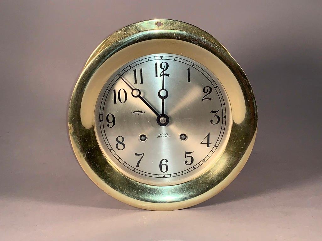 Chelsea Ship's Bell Clock: Chelsea Ship's Bell Clock, Circular case in brass with metal dial with Arabic numerals, with Storm and Fair dial. Marked Chelsea Ship's Bell. 7.25 in. dia x 3.5 in.d.