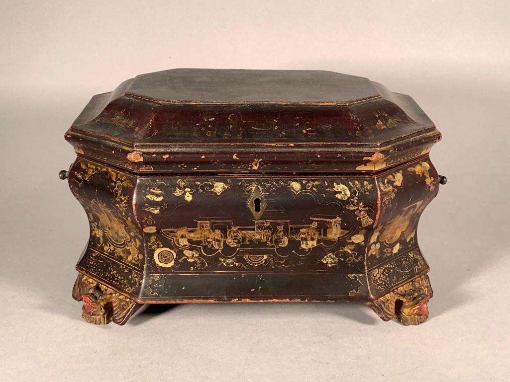 Chinese Export Lacquer Tea Caddy: Chinese Export Lacquer Tea Caddy, shaped hexagonal form in brownish black lacquer with bail handles, decorated with gatherings of figures on a veranda, the interior with gilded fern fronds, the interi