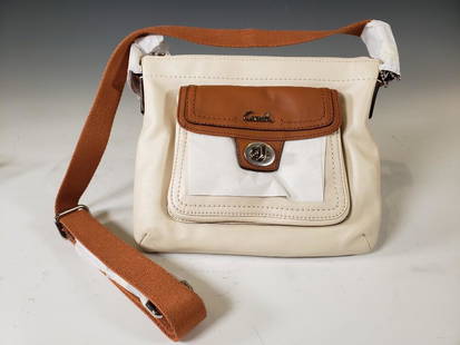 Coach Leather Pocket Swingpack, White/Caramel NWT: Coach® Leather Pocket Swingpack. White/Caramel Leather; Palladium Hardware. Model Number: F45012. Dimensions: 7.25 x 9 in. Condition: New and unused in wraps. NEUE Auctions is not