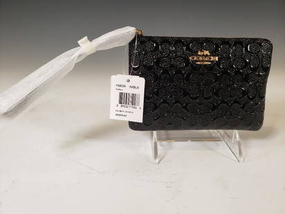 Coach Debossed Patent Leather Corner Zip Wristlet in: Coach® Debossed Patent Leather Corner Zip Wristlet in Black. Embossed Patent Leather; Brass Hardware. Model Number: F58034. Dimensions: 4.5 x 6 in. Condition: New and unused. NEUE