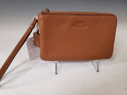 Coach Pebble Leather Double Corner Zip Wristlet, NWT: Coach® Pebble Leather Double Corner Zip Wristlet, Saddle Dark Tan. Saddle Leather and Palladium Hardware. Model Number: F66505. Suggested Retail $95.00 Dimensions: 4.25 x 6.25 in. Condition: New and