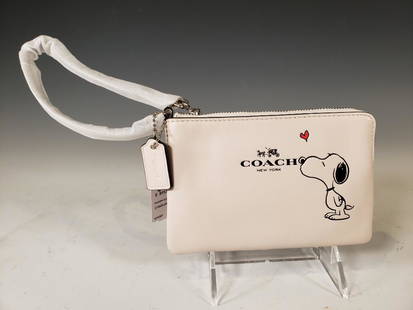 Coach Snoopy Peanuts Corner Zip Wristlet, Chalk NWT: Coach® Peanuts Snoopy Corner Zip Wristlet, Chalk Saddle Leather. Chalk Saddle Leather and Palladium Hardware. Model Number: F65193. Suggested Retail $95.00 Dimensions: 4.25 x 6.25 in. Condition: New