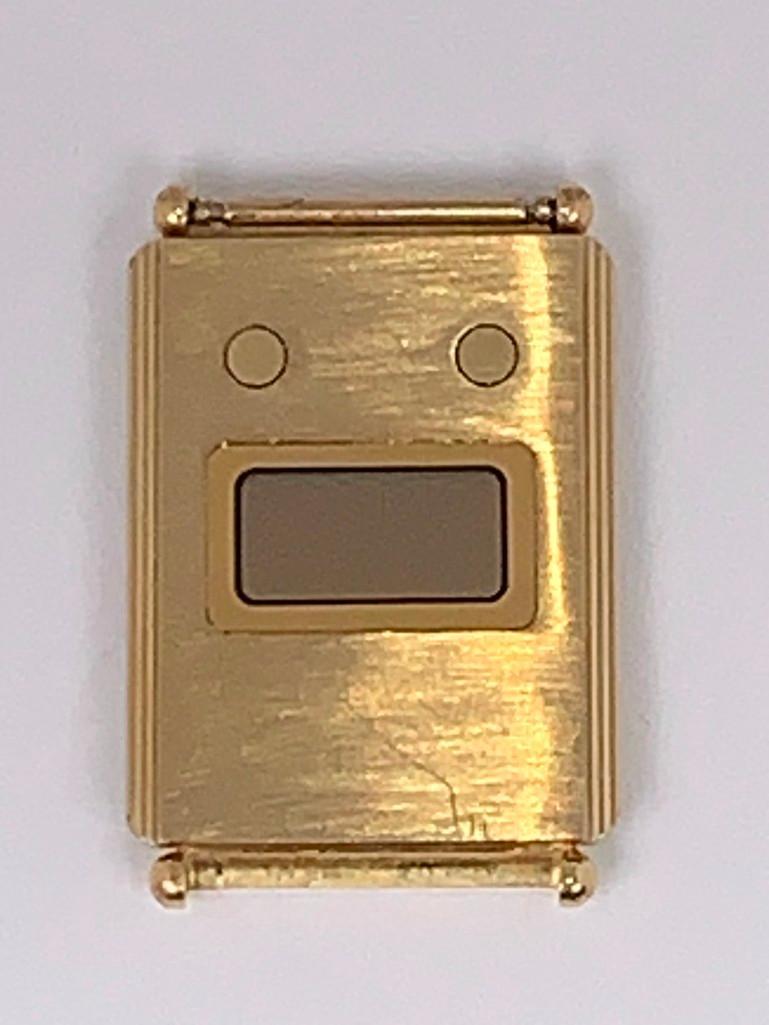 Bulova Phantom LCD 18 Kt Gold Watch, 1979: Thin digital watch. Weight 15.29 grams, marked 18 karat yellow gold case, without strap and missing one strap pin, matte finish watch face with horizontal aperature with two flat push buttons, marke o