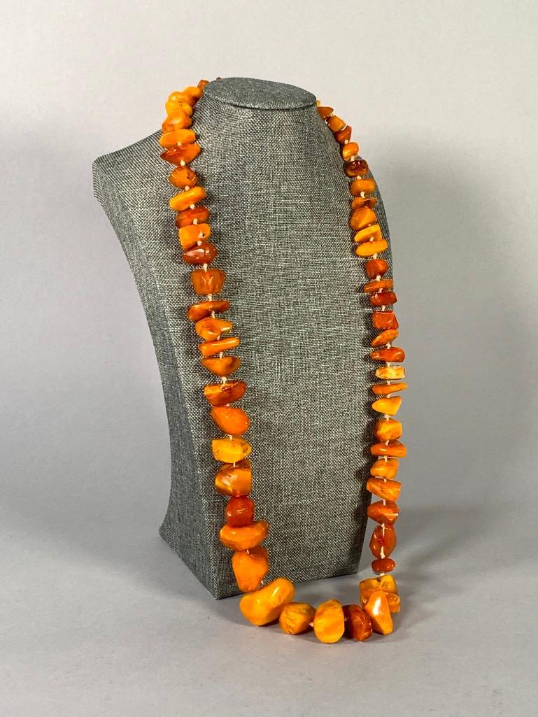 Natural Butterscotch Amber Bead Strand: Natural Butterscotch Amber Bead Strand, graduated irregular chunks on approximate 28 inch length strand. Weight: 110 g. Dimensions: 28 in.l. Condition: Very good.