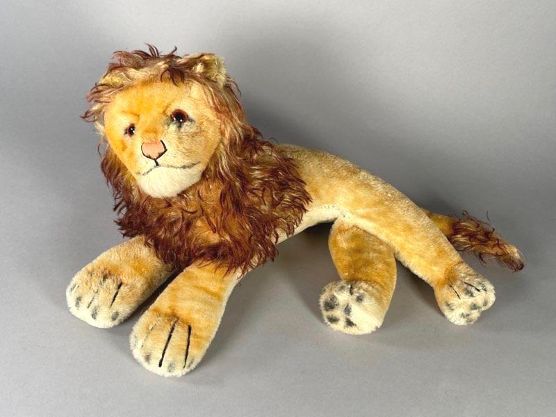 Steiff Mohair Recumbent Lion: Steiff Mohair Recumbent Lion, with curly mohair mane and tail. Dimensions: 10 x 17 in. Condition: As is with wear.