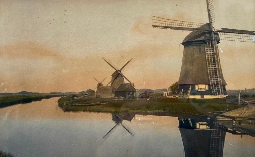 Wallace Nutting, "The Mills at the Turn": Wallace Nutting (American 1861-1941) "The Mills at the Turn," hand-colored photograph, signed in ink lower right, titled lower left, framed. Dimensions: 6 x 9.5 image size 13.5 x 16.75 as framed. Cond