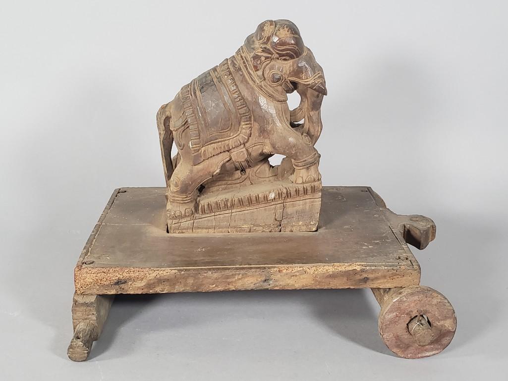 Indian Carved Wood Child's Pull Toy, Elephant: Antique Indian Carved Wood Child's Pull Toy, in the form of an Elephant, the carved figure on a wood platform raised on wheels. Condition: Lacking one wheel. Wear and tear, nice vintage condition.