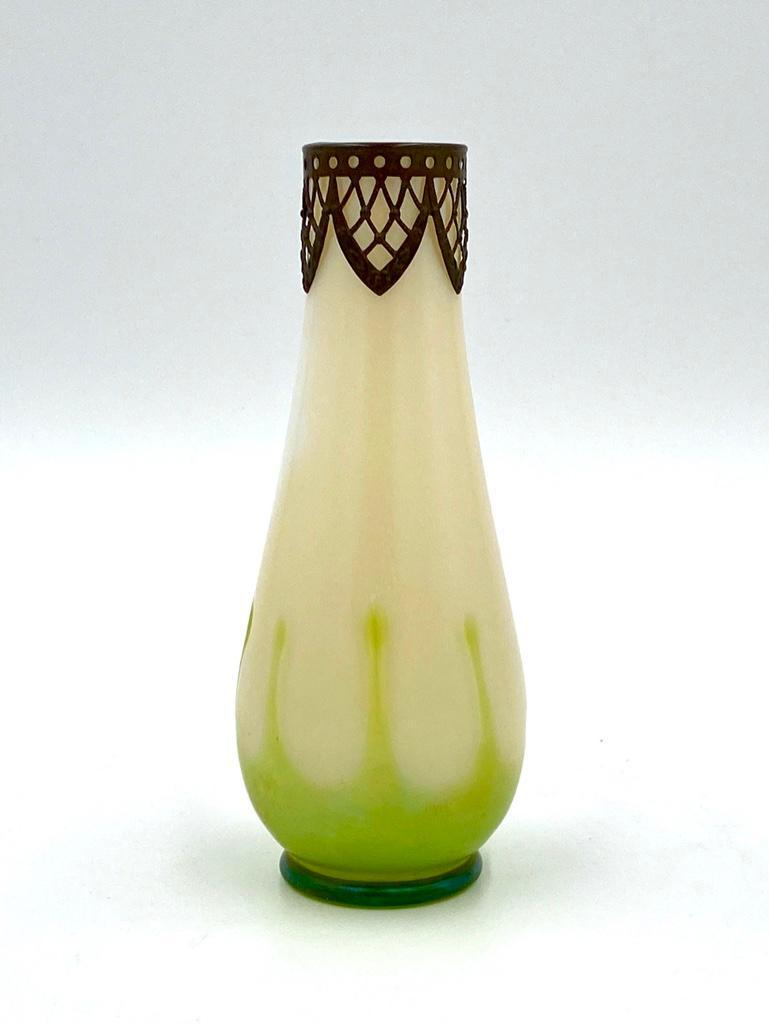 Loetz or Czechoslovakian Iridescent Art Glass Vase: Loetz or Czechoslovakian Iridescent Art Glass Vase, cylindrical form tapering toward the neck, on circular foot, in opaque iridescent glass with pale green applied forms around the base, the neck with