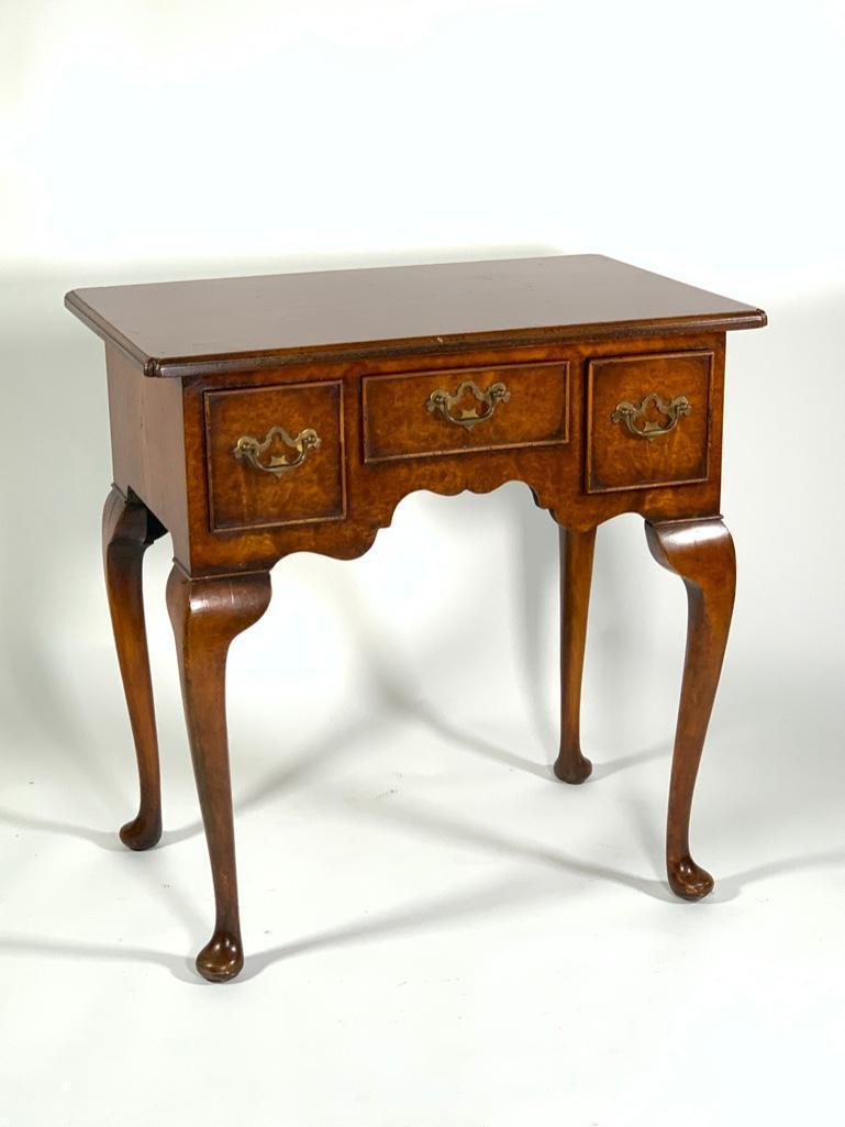 English Burl Wood Lowboy, 20thc.: English Burl Wood Lowboy, 20thc. Rectangular top over three frieze drawers raised on cabriole legs ending in pad feet. Dimensions: 27.5 x 27 x 18 in. Condition: Good Condition. Provenance: Colle
