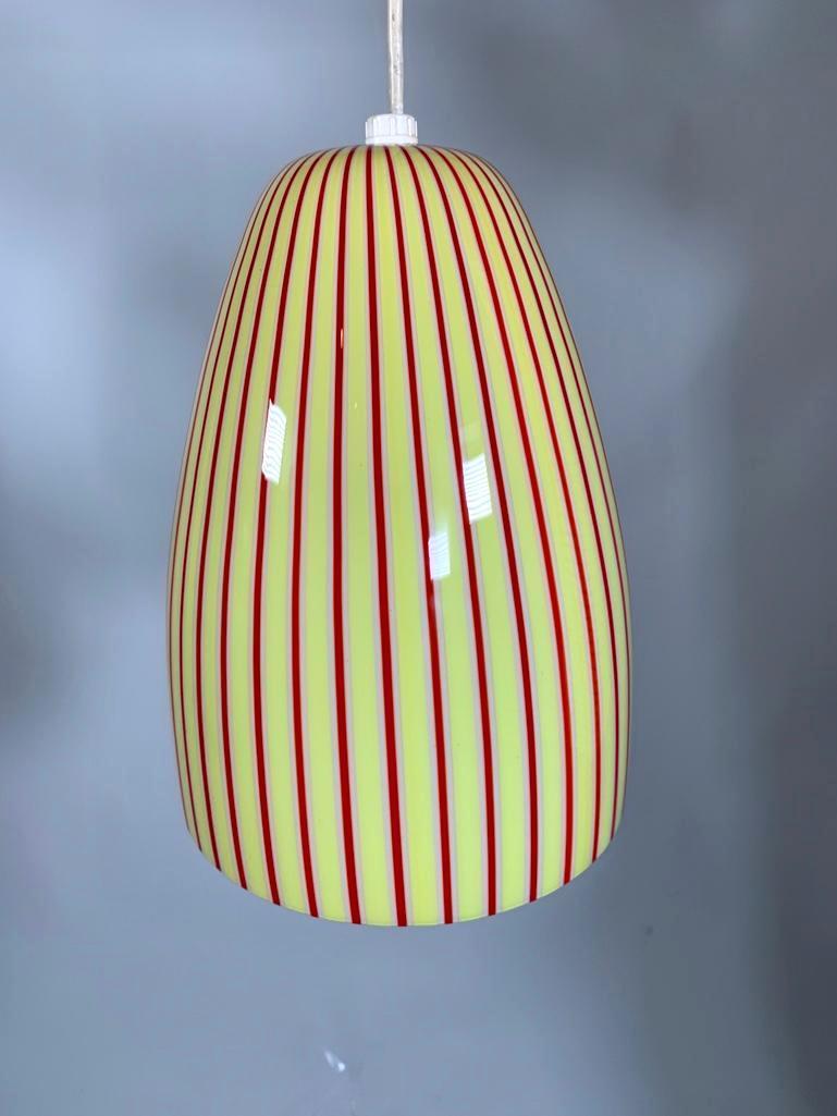Venini Pendant Glass Lamp: Venini Pendant Glass Lamp, c.1950's-60's, mold blown and cased form in opaque white glass with an expanding pattern of vertical stripes in yellow and red. With metal canopy and white cord, wit