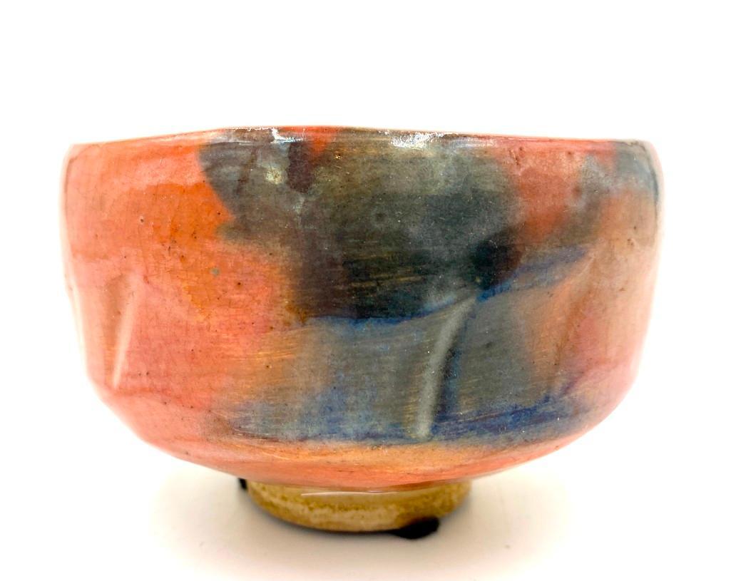 Japanese Glazed Pottery Teabowl: Japanese Glazed Pottery Teabowl, footed form with 'carved' texture, the buff bisque body covered in a terracotta colored glaze with ash colored organic formed spots. Impressed mark to base. Di