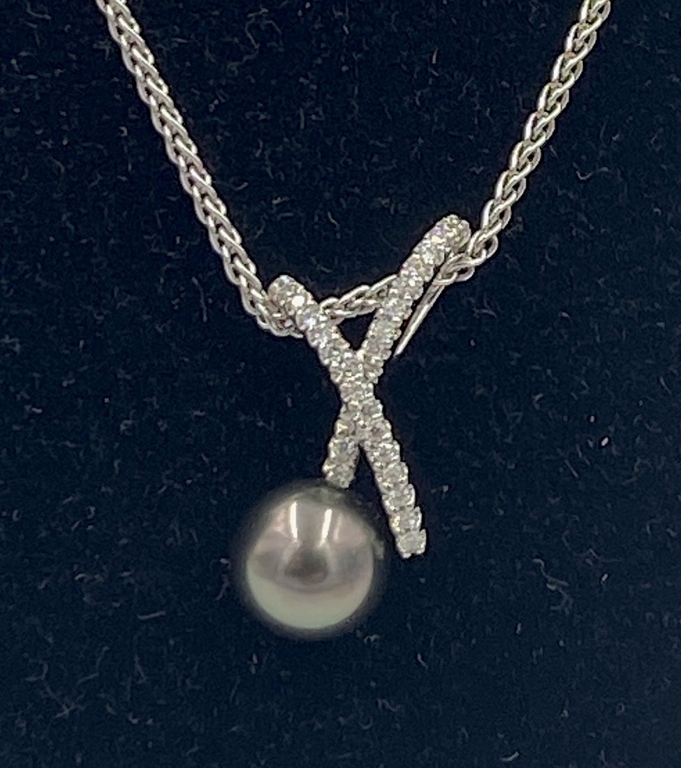 Dahlia Tahitian Black Pearl and Diamond Pendant on: 18K white gold pendant with pave set round cut diamonds, apprx .18 cts. with attached 9.5 mm black Tahitian pearl, suspended from a 14K white gold 16"L chain, overall apprx 7 grams.