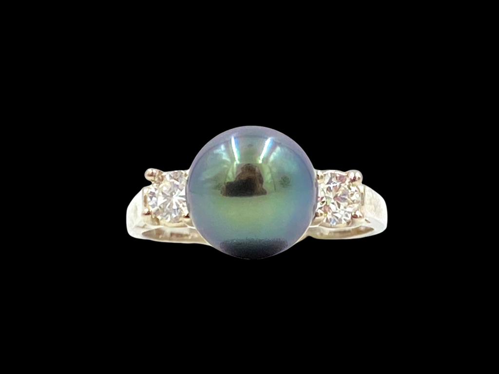 Mastoloni Tahitian Pearl and Diamond: 18K white gold set with a 9mm Tahitian pearl, with two side diamonds, round cut and prong set, apprx .40 cts. tdw., 5.1 grams. Ring size approximate 6.5.