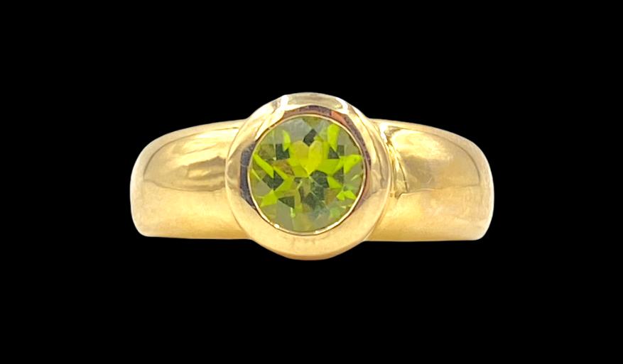 Church & Company Peridot Ring: 14K yellow gold ring, with a bezel set round cut Peridot, 6.3 grams. Ring size approximate 5.5.